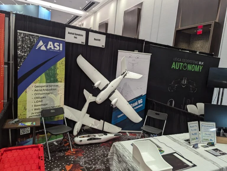 A photo of 2 fixed wing drones on display at an expo