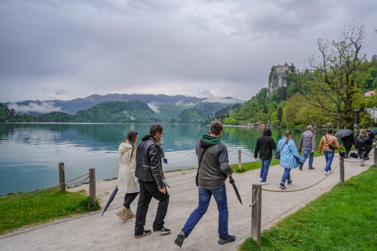 People walking near a lake