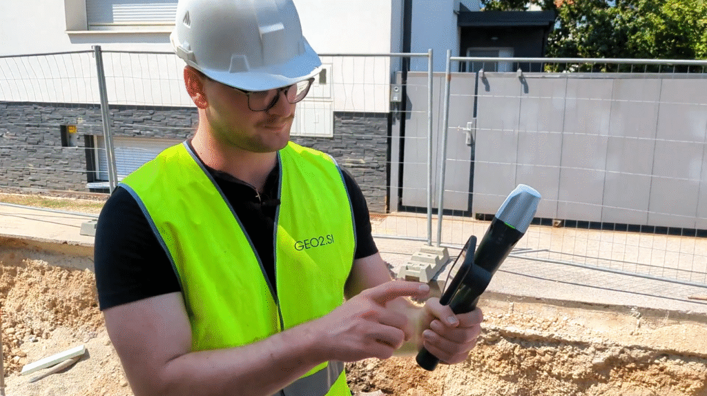Surveyor using a smartphone with GNSS antennae