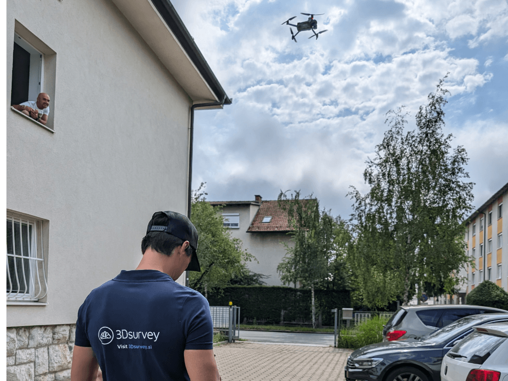Drone pilot operating a drone, to capture a building.