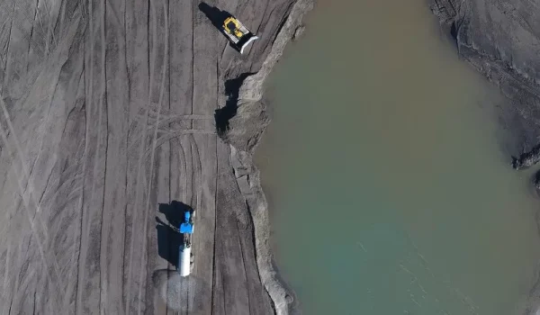 Top down image of a truck and digger on a subsidence mining project